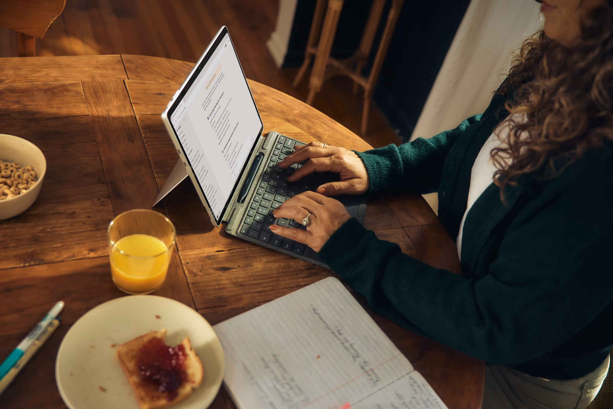 Working through a document on a laptop at a kitchen table
